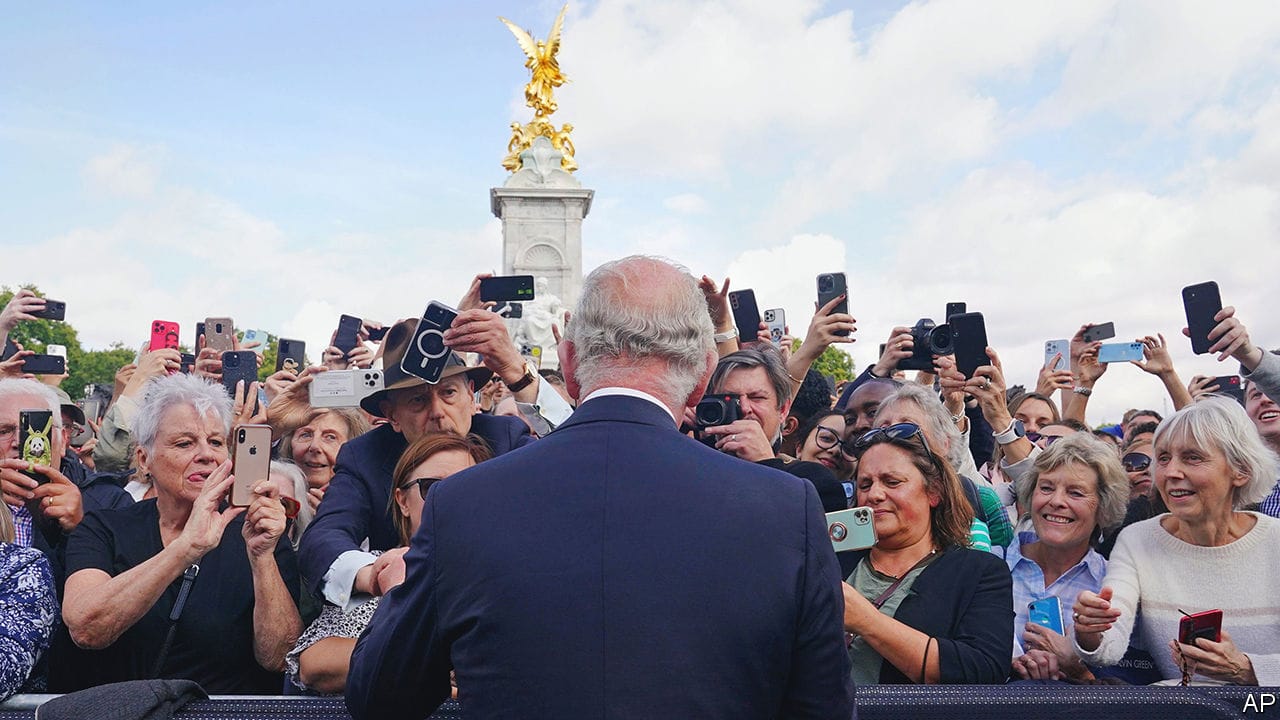 Britain's King Charles III, back to camera, greets well-wishers as he walks by the gates of Buckingham Palace following Thursday's death of Queen Elizabeth II, in London, Sept. 9, 2022. (Yui Mok/Pool Photo via AP)