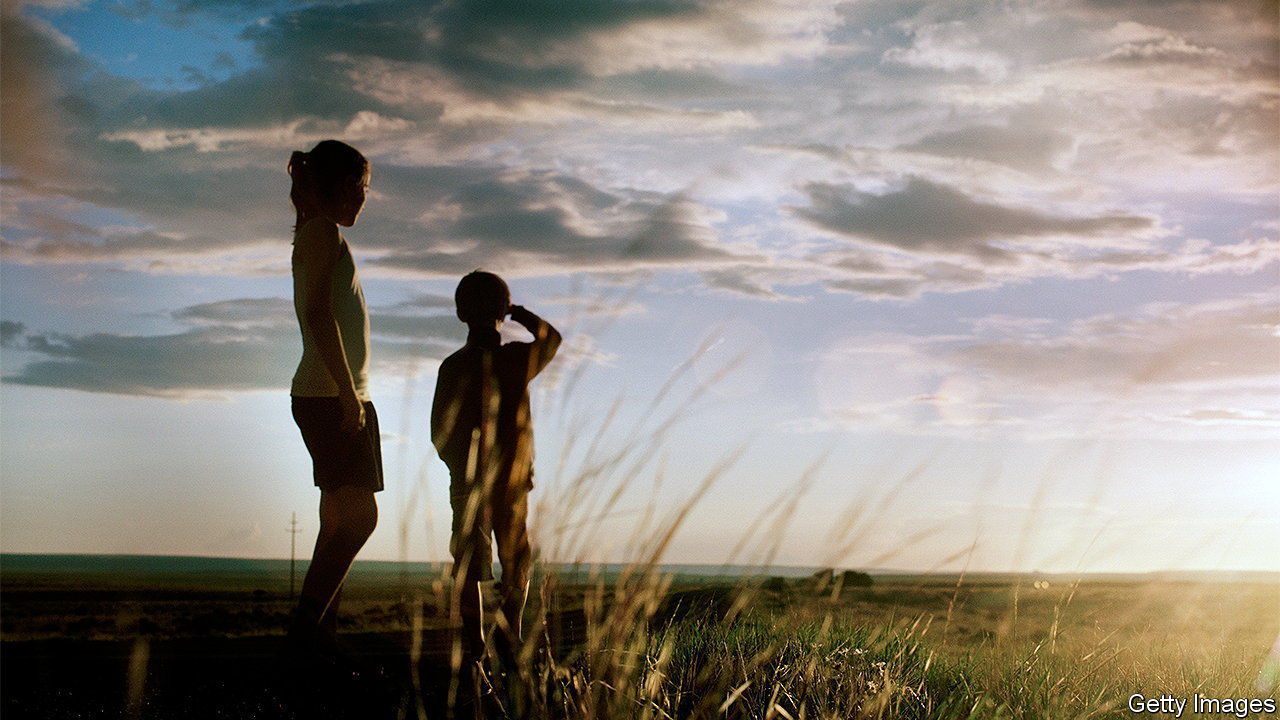 brother and sister by the side of the road,in the middle of nowhere, looking at sun set.